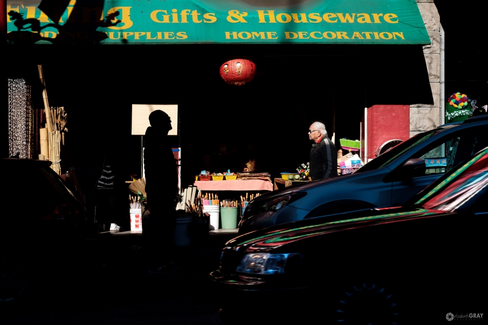 Gifts and Houseware - In my first attempts to capture this photo, the silhouetted figure was not centred within the bright sign. Luckily, he was waiting for someone and I could move slightly so that his entire head was silhouetted. I got lucky when a dark car drove past, adding reflections to the foreground.